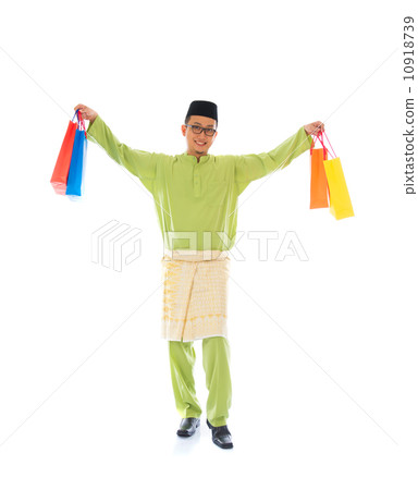 Traditional Malay male shopping and jumping in joy during hari r Traditional Malay male shopping and jumping in joy during hari r 10918739