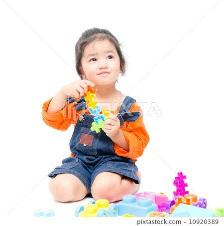 Isolated asian kid girl playing with toys 10920389