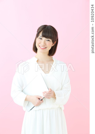 Young girl with laptop · Pink back 10920434