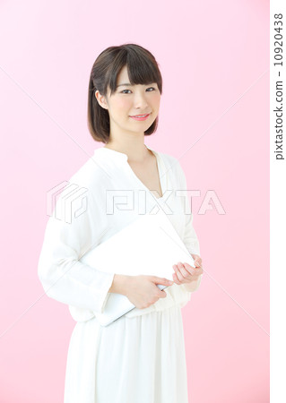 Young girl with laptop · Pink back Young girl with laptop · Pink back 10920438