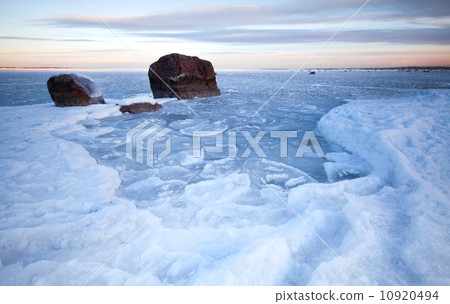 Winter landscape with ice and stones on frozen Baltic Sea 10920494