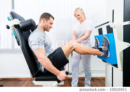 Physiotherapist exercising patient in sport therapy 10920951