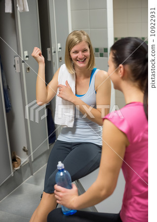 Woman showing muscles in gym's locker room 10922931