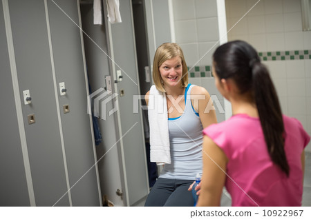 Woman talking with friend in changing room Woman talking with friend in changing room 10922967