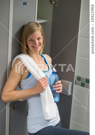 Happy woman in locker room at healthclub 10922968