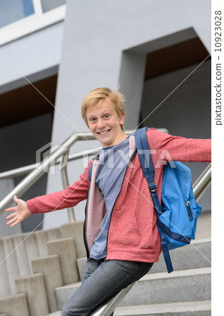 Excited student sliding down railing on stairway Excited student sliding down railing on stairway 10923028