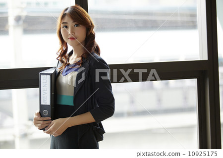 Young asian business woman holding file document Young asian business woman holding file document 10925175