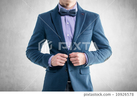Handsome elegant young fashion man in coat tuxedo classical costume suit and bow tie 10926578