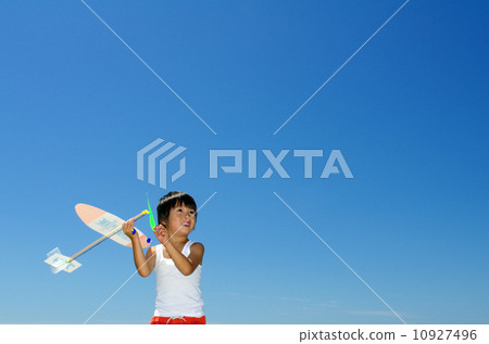 A child trying to fly a model plane 10927496