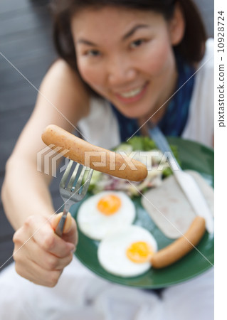 attractive woman giving a sausage 10928724