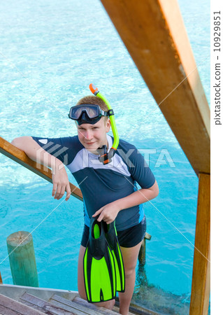 The boy with flippers, mask and tube for scuba diving. Maldives 10929851