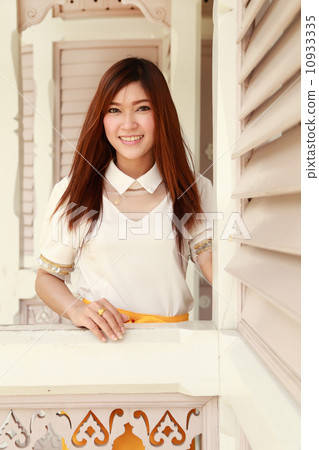 woman smiles in traditional wood house woman smiles in traditional wood house 10933335