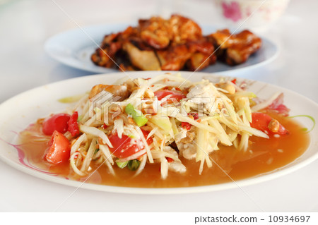 spicy papaya salad and roasting chicken 10934697