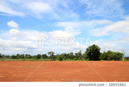 Landscape of Bare Earth and tree with a Beautiful Blue Sky Above 10935862