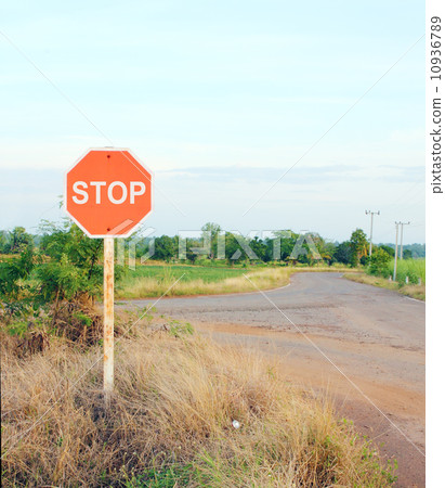 stop sign in a country road stop sign in a country road 10936789