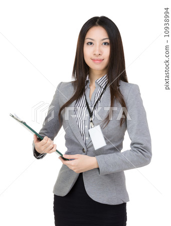 Smiling businesswoman with pen and clipboard 10938994