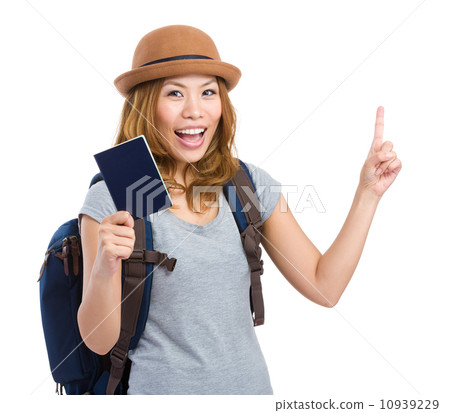Woman traveler holding passport and finger pointing up 10939229