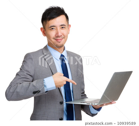 Businessman holding laptop and finger pointing to screen Businessman holding laptop and finger pointing to screen 10939589