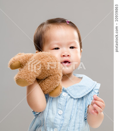 Baby girl holding her bear doll Baby girl holding her bear doll 10939863