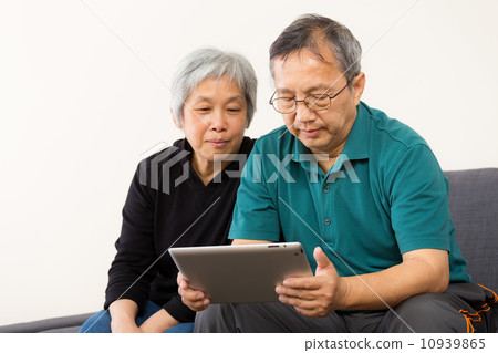 Asia couple using tablet at home Asia couple using tablet at home 10939865