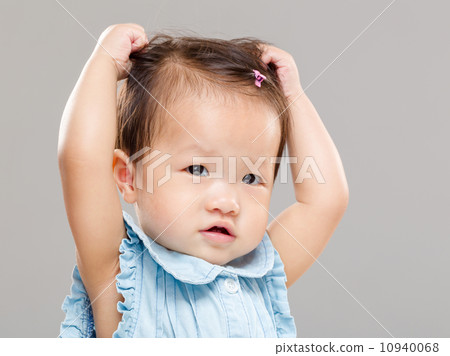 Baby scratching hair Baby scratching hair 10940068