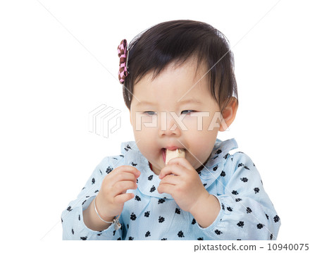 Asian baby girl eating candy Asian baby girl eating candy 10940075