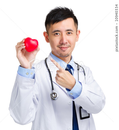 Medical doctor holding heart squeezing ball 10940334