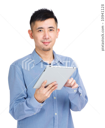 Young man touching on tablet Young man touching on tablet 10941128