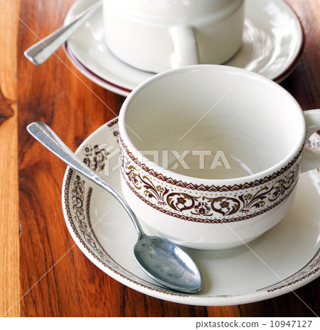 An empty cup of coffee on a wooden table An empty cup of coffee on a wooden table 10947127