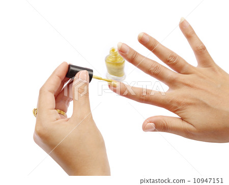 female hand with a golden nail polish on white 10947151