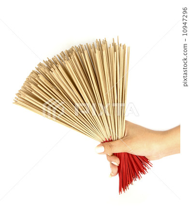 hand holding incense on white background hand holding incense on white background 10947296