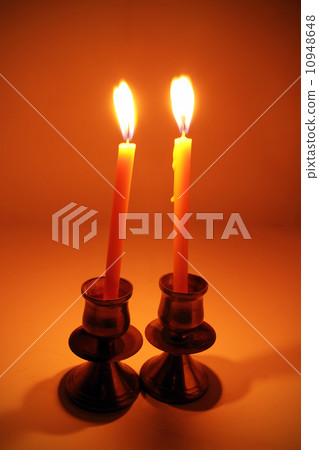 burning candle with antique metal candlestick 10948648