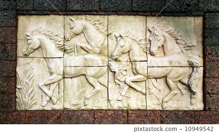 Stone sculpture of horse on wall 10949542