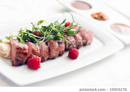 grilled duck breast covered with sweet red fruit sauce grilled duck breast covered with sweet red fruit sauce 10950276