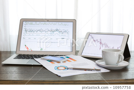 Laptop, tablet , smartphone and coffee cup with financial docume Laptop, tablet , smartphone and coffee cup with financial docume 10957758