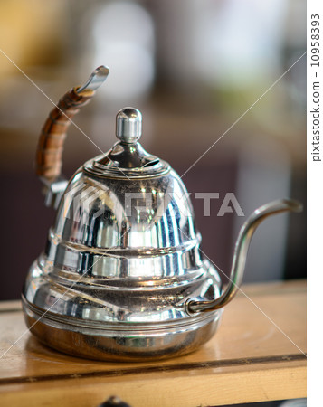 Hot coffee pot on wooden table. 10958393