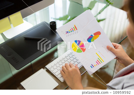 Business woman working in office with financial diagram Business woman working in office with financial diagram 10959592