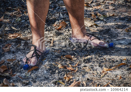 Hobo standing in bottle sandals on wood ashes 10964214
