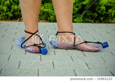 Thrifty woman wearing plastic bottle sandals 10964220