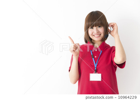 A finger pointing with a smile, a young female operator wearing a polo shirt in cool biz A finger pointing with a smile, a young female operator wearing a polo shirt in cool biz 10964229
