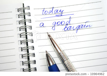 Blue and silvery pens on the note book 10964962