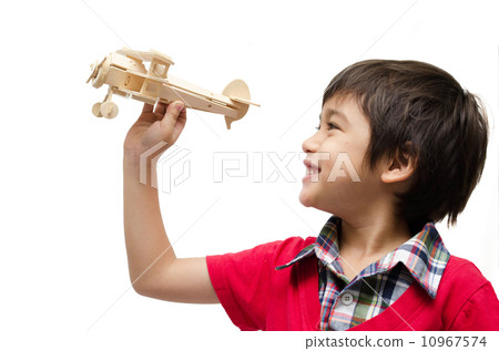 little boy playing with a toy airplane. Isolated on white backgr 10967574
