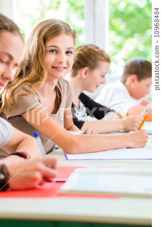 Students writing a test in school concentrating 10968484