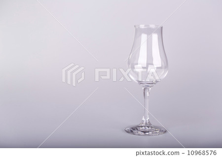 Empty glass for rum on white background Empty glass for rum on white background 10968576