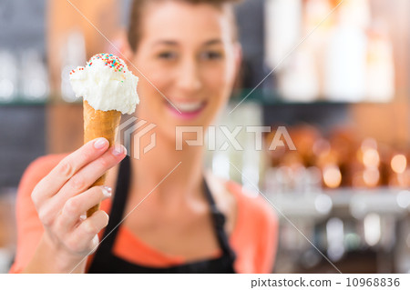 Female seller in Parlor with ice cream cone 10968836