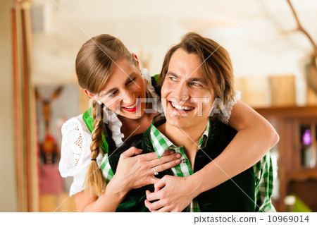Young couple in traditional Bavarian Tracht in restaurant or pub Young couple in traditional Bavarian Tracht in restaurant or pub 10969014