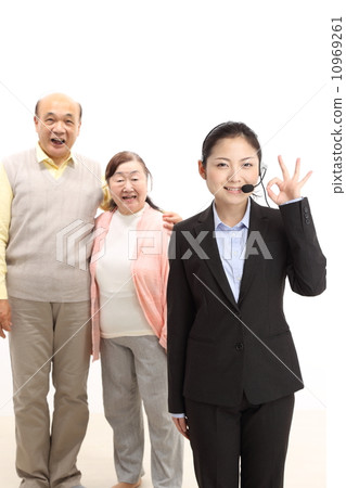 Senior couple and female operator Senior couple and female operator 10969261