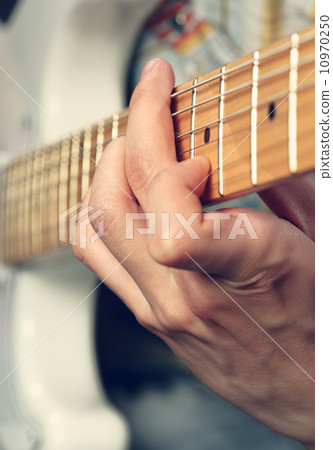 Guitarist playing an electric guitar Guitarist playing an electric guitar 10970250