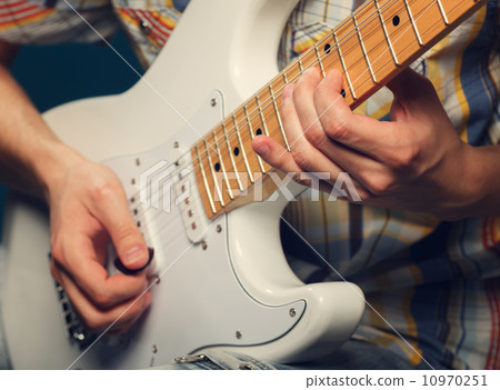 Guitarist playing an electric guitar Guitarist playing an electric guitar 10970251
