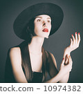 Portrait of young woman in a black hat. 10974382